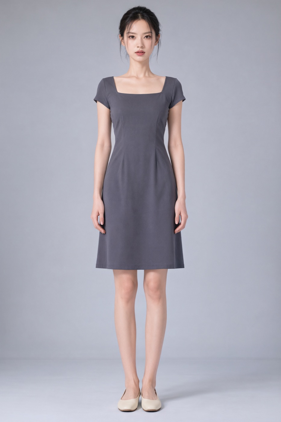 Full-length studio portrait in a charcoal square-neck dress